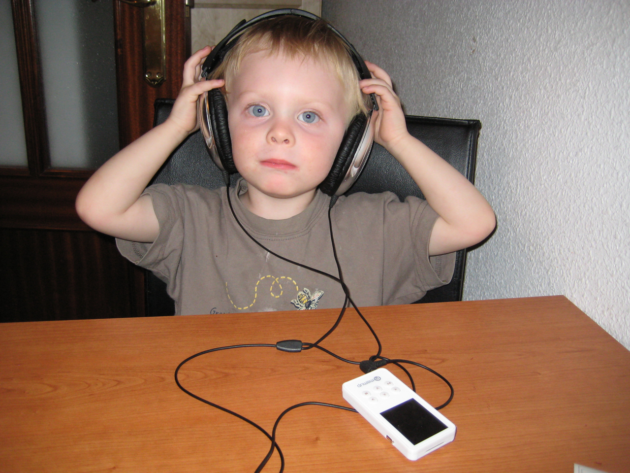 Listening to music on his music player.